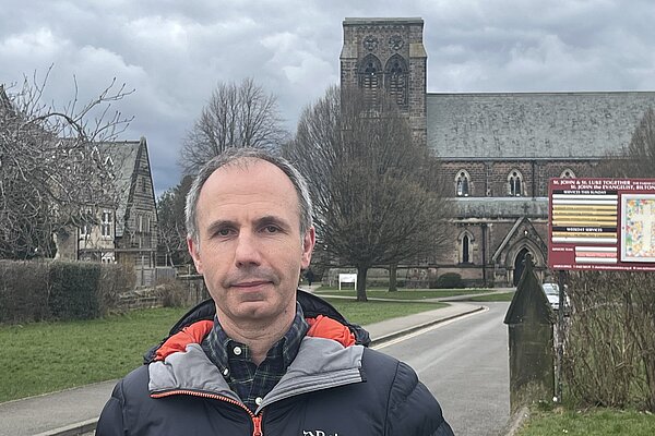 David Allerdyce stood in front of St John's Church, Bilton