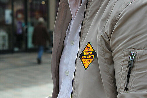 a person wearing a Lib Dem sticker