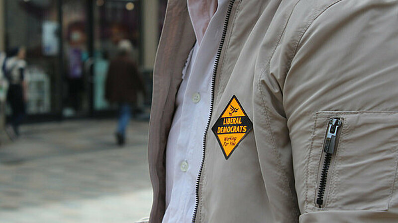 a person wearing a Lib Dem sticker